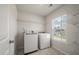 Convenient laundry room featuring a washer, dryer, and shelving for organized storage at 1311 Berry Grove Dr, Summerville, SC 29485