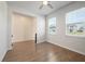 Bright living room featuring wood-look floors, a ceiling fan, and two windows at 1311 Berry Grove Dr, Summerville, SC 29485
