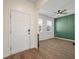 Living room featuring wood-look floors, a ceiling fan, and a dark accent wall at 1311 Berry Grove Dr, Summerville, SC 29485