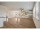Open-concept living room with wood-look flooring, a statement wall, and a ceiling fan at 1311 Berry Grove Dr, Summerville, SC 29485