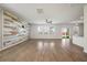 Spacious living room with a ceiling fan, wood-look flooring, and a decorative wood accent wall at 1311 Berry Grove Dr, Summerville, SC 29485