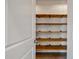 Walk-in pantry featuring multiple rows of rustic wood shelving for optimal storage space at 1311 Berry Grove Dr, Summerville, SC 29485