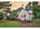 Back of house featuring a lush yard, tidy landscaping and a screened-in porch for outdoor enjoyment at 1311 Royal Links Dr, Mount Pleasant, SC 29466