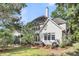 Spacious backyard featuring well-maintained lawn and mature trees surrounding the home at 1311 Royal Links Dr, Mount Pleasant, SC 29466