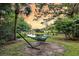 Lush backyard features a hammock and view of the beautiful pond at 1311 Royal Links Dr, Mount Pleasant, SC 29466