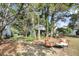 Inviting backyard features mature trees, outdoor seating, and a view of the home's screened porch at 1311 Royal Links Dr, Mount Pleasant, SC 29466