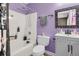 Well-lit bathroom featuring a tub-shower with lavender walls, along with a single sink vanity and linoleum flooring at 1311 Royal Links Dr, Mount Pleasant, SC 29466