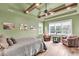 Inviting bedroom with wood beam ceilings, comfortable seating, and beach-themed artwork at 1311 Royal Links Dr, Mount Pleasant, SC 29466