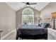 Bedroom with a vaulted ceiling and large arched window allowing lots of natural light and light colored carpet at 1311 Royal Links Dr, Mount Pleasant, SC 29466