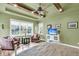 Serene primary bedroom featuring decorative tray ceiling, accent seating, and ample natural light at 1311 Royal Links Dr, Mount Pleasant, SC 29466