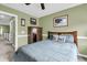 Bedroom with green walls featuring a bed with decorative pillows, a dresser and view to a stairway at 1311 Royal Links Dr, Mount Pleasant, SC 29466