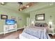 Spacious primary bedroom with tray ceilings, recessed lights, hardwood floors, and calming green walls at 1311 Royal Links Dr, Mount Pleasant, SC 29466