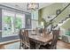Elegant dining room with large windows, stylish chandelier and views of the staircase at 1311 Royal Links Dr, Mount Pleasant, SC 29466