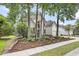 Charming two-story home with lush landscaping, a well-maintained lawn, and a three-car garage at 1311 Royal Links Dr, Mount Pleasant, SC 29466