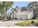 Stately two-story home with a three-car garage, well-manicured landscaping, and a spacious driveway at 1311 Royal Links Dr, Mount Pleasant, SC 29466