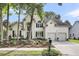 Beautiful two-story home with lush landscaping, a welcoming entrance, and a three-car garage at 1311 Royal Links Dr, Mount Pleasant, SC 29466