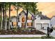 Charming two-story home with a well-manicured lawn, flower beds, and a two-car garage at 1311 Royal Links Dr, Mount Pleasant, SC 29466