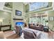Spacious living room featuring tall windows, vaulted ceiling, and comfortable leather furniture at 1311 Royal Links Dr, Mount Pleasant, SC 29466
