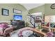 Inviting living room with a staircase, green walls, decor, a TV, and an open dining area at 1311 Royal Links Dr, Mount Pleasant, SC 29466