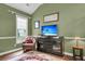 Cozy living room with an olive-green wall, a large window, an armchair, and a media center at 1311 Royal Links Dr, Mount Pleasant, SC 29466