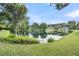 Scenic pond view reflecting the surrounding lush landscape and clear sky at 1311 Royal Links Dr, Mount Pleasant, SC 29466