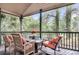 Comfortable porch with wooden furniture and serene, wooded views at 1311 Royal Links Dr, Mount Pleasant, SC 29466