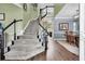 Elegant staircase leading to the upper level, open to a dining area and living space at 1311 Royal Links Dr, Mount Pleasant, SC 29466