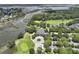 An aerial view showcasing a clubhouse, pristine golf course, waterway, and stunning residential community at 132 Fresh Meadow Ln, Mount Pleasant, SC 29466
