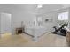 Cozy bedroom featuring a comfortable bed, tray ceilings, and a Peloton exercise bike at 132 Fresh Meadow Ln, Mount Pleasant, SC 29466
