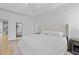 Bright bedroom with a soft upholstered bed and an adjoining room visible through the doorway at 132 Fresh Meadow Ln, Mount Pleasant, SC 29466
