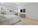Comfortable bedroom with a ceiling fan, tray ceiling, TV, and Peloton exercise bike at 132 Fresh Meadow Ln, Mount Pleasant, SC 29466