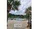 One of 3 community pools surrounded by lounge chairs and palm trees for relaxing fun at 132 Fresh Meadow Ln, Mount Pleasant, SC 29466