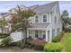 Stylish townhome with a two-car garage, covered front porch, and lush landscaping at 132 Fresh Meadow Ln, Mount Pleasant, SC 29466