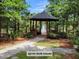 Picturesque gazebo surrounded by lush trees with a water feature in the background at 132 Fresh Meadow Ln, Mount Pleasant, SC 29466