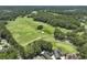 Aerial view of a lush green golf course with mature trees, meticulously maintained fairways, and manicured greens at 132 Fresh Meadow Ln, Mount Pleasant, SC 29466