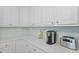 Close-up of white kitchen cabinets with quartz countertops at 132 Fresh Meadow Ln, Mount Pleasant, SC 29466