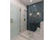 Glass enclosed shower with rainfall showerhead and custom tile, with marble bench at 14 55Th Ave, Isle of Palms, SC 29451