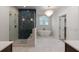 Elegant bathroom featuring a glass shower, a chandelier, and a soaking tub next to a window at 14 55Th Ave, Isle of Palms, SC 29451