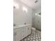 Bathroom features dual sinks, white cabinets, tiled floors, and a glass enclosed walk-in shower at 14 55Th Ave, Isle of Palms, SC 29451