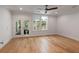 Bright bedroom with hardwood floors, neutral walls, ceiling fan and access to private balcony at 14 55Th Ave, Isle of Palms, SC 29451