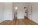 Bright bedroom with hardwood floors, white trim, and two doors, one leading to a bathroom at 14 55Th Ave, Isle of Palms, SC 29451