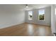 Serene bedroom featuring hardwood floors, neutral walls, and sunny windows with treetop views at 14 55Th Ave, Isle of Palms, SC 29451