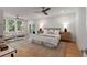 Main bedroom has hardwood floors, a ceiling fan, and a sitting area with tree views at 14 55Th Ave, Isle of Palms, SC 29451