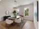 Dining room with modern lighting, large windows, and seating for six at 14 55Th Ave, Isle of Palms, SC 29451