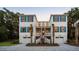 Charming two-story home with blue shutters, dual garages, and well-manicured landscaping at 14 55Th Ave, Isle of Palms, SC 29451