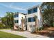 Charming two-story home with blue shutters, dual garages, and well-manicured landscaping at 14 55Th Ave, Isle of Palms, SC 29451