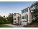 Charming two-story home with blue shutters, well-manicured lawn, and a welcoming driveway at 14 55Th Ave, Isle of Palms, SC 29451
