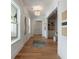 Bright hallway with hardwood floors, modern lighting, and built-in shelving at 14 55Th Ave, Isle of Palms, SC 29451