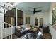 Inviting outdoor living space with comfortable seating, ceiling fan, and views of the surrounding landscape at 14 55Th Ave, Isle of Palms, SC 29451