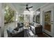 Covered outdoor porch featuring comfortable wicker seating and a spiral staircase at 14 55Th Ave, Isle of Palms, SC 29451